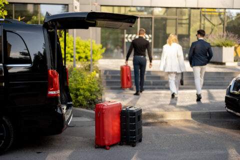 Driver helping a customer with the suitcases